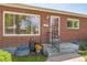 Charming brick home with a well-maintained front yard, porch, and a secure entrance, perfect for families at 2902 S Meade St, Denver, CO 80236