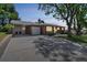 A well-maintained home featuring a carport and large concrete driveway at 2902 S Meade St, Denver, CO 80236