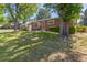 Charming brick home with a well-manicured lawn and mature trees in a serene setting at 2902 S Meade St, Denver, CO 80236