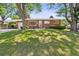 Charming brick home with well-maintained lawn and mature trees, offering great curb appeal at 2902 S Meade St, Denver, CO 80236
