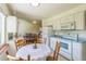 Open kitchen with white appliances and cabinetry, seamlessly connected to the dining and living areas at 2902 S Meade St, Denver, CO 80236