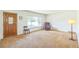 Bright living room with neutral carpet, large window, and cozy seating at 2902 S Meade St, Denver, CO 80236