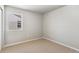 This bedroom features neutral walls, carpet flooring, and a window providing natural light at 48195 Shetland Dr, Bennett, CO 80102