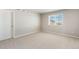 Bright bedroom with neutral carpet, window, and ample natural light at 48195 Shetland Dr, Bennett, CO 80102