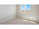 This cozy bedroom features neutral carpet, a window, and fresh paint at 48195 Shetland Dr, Bennett, CO 80102