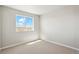 This bedroom boasts plush carpeting, a large window, and fresh paint at 48195 Shetland Dr, Bennett, CO 80102