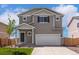 Charming two-story home featuring a two car garage, gray siding and a well-maintained front yard with lawn at 48195 Shetland Dr, Bennett, CO 80102