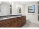 Double vanity bathroom with granite countertops and updated tile at 8035 Garrison Ct # A, Arvada, CO 80005