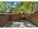 Private patio with wood fencing and adjacent building view at 8035 Garrison Ct # A, Arvada, CO 80005