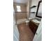 Bathroom featuring a vanity with granite countertops, shelves, tub, and tiled walls at 1245 Yates St, Denver, CO 80204