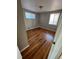 Bedroom with hardwood floors, neutral paint and natural light from two windows at 1245 Yates St, Denver, CO 80204