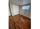 Bedroom with hardwood floors, closet, neutral paint and natural light from a window at 1245 Yates St, Denver, CO 80204