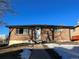 Brick exterior of a single-story home with a well-maintained front yard at 1245 Yates St, Denver, CO 80204