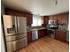 Spacious kitchen featuring stainless steel appliances, wood cabinets, and granite countertops at 1245 Yates St, Denver, CO 80204
