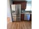 Modern kitchen with stainless steel refrigerator, wooden cabinets, and granite countertops at 1245 Yates St, Denver, CO 80204