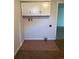 Laundry room with tile flooring and overhead cabinets for storage at 1245 Yates St, Denver, CO 80204
