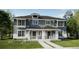 Two-story craftsman style home with gray siding, stone accents, and a front porch at 15242 Detroit St, Thornton, CO 80602