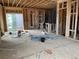 Interior framing of a home with exposed beams, plywood flooring and electrical wiring at 15242 Detroit St, Thornton, CO 80602