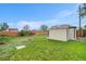 Backyard features a storage shed, lush green grass, and a wood fence at 5491 Lowell Blvd, Denver, CO 80221
