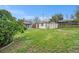 Large backyard with lush grass, sheds, and a wood fence at 5491 Lowell Blvd, Denver, CO 80221