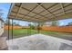 Covered backyard patio with concrete floor and gravel surrounding at 5491 Lowell Blvd, Denver, CO 80221