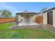 Backyard patio features a covered area with concrete and gravel landscaping at 5491 Lowell Blvd, Denver, CO 80221