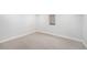 Finished basement area with neutral carpet and white walls at 5491 Lowell Blvd, Denver, CO 80221