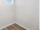 Empty basement area with wood flooring and minimal natural light at 5491 Lowell Blvd, Denver, CO 80221
