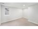 Carpeted basement space featuring a window and neutral color palette at 5491 Lowell Blvd, Denver, CO 80221