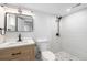 Modern bathroom with neutral tones and sleek fixtures, including a tiled shower at 5491 Lowell Blvd, Denver, CO 80221