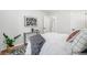 A cozy bedroom showcases white bedding and modern minimalist decor at 5491 Lowell Blvd, Denver, CO 80221
