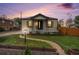 Lovely home boasting a well-kept lawn, walkway, and cozy front porch at 5491 Lowell Blvd, Denver, CO 80221