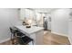 Eat-in kitchen featuring updated appliances, quartz countertops, and modern barstools at 5491 Lowell Blvd, Denver, CO 80221