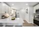 Modern kitchen featuring stainless steel appliances, white cabinetry, and quartz countertops at 5491 Lowell Blvd, Denver, CO 80221