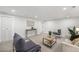 Bright living room featuring modern neutral paint, carpet, and furniture at 5491 Lowell Blvd, Denver, CO 80221