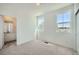 Bedroom features ample light, plush carpet, and an ensuite bathroom at 708 N Bently St, Watkins, CO 80137