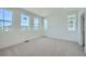 Spacious bedroom with plush carpet and bright natural light from several windows at 708 N Bently St, Watkins, CO 80137