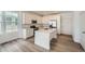 Modern kitchen with stainless steel appliances and a bright white island at 708 N Bently St, Watkins, CO 80137