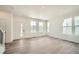 Bright, open-concept living area with hardwood floors and large windows at 708 N Bently St, Watkins, CO 80137