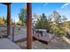 A relaxing outdoor hot tub on a wood deck with scenic views and natural surroundings at 6899 Osprey Ln, Evergreen, CO 80439