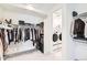 Walk-in closet equipped with ample shelving and organization space, with laundry in the next room at 1159 Sunrise Dr, Erie, CO 80516