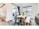 Bright dining room with natural light, a stylish table setting, and a patio view at 1159 Sunrise Dr, Erie, CO 80516