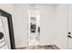 Hallway leading to the laundry room and closet areas, with luxury vinyl plank flooring at 1159 Sunrise Dr, Erie, CO 80516