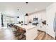 Modern kitchen with stainless steel appliances, a center island with seating, and a dining area at 1159 Sunrise Dr, Erie, CO 80516