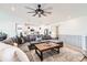 Open concept living room with comfortable sectional, ceiling fan, and modern finishes at 1159 Sunrise Dr, Erie, CO 80516