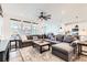 Spacious living room with large sectional sofa, ceiling fan, and lots of natural light at 1159 Sunrise Dr, Erie, CO 80516