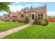 Stone house with a well-maintained lawn and walkway at 3050 Bellaire St, Denver, CO 80207