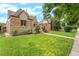 Brick and stone house with a lush lawn at 3050 Bellaire St, Denver, CO 80207