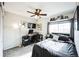 Well-lit bedroom featuring a dedicated workspace, neutral walls, and plush carpet at 9267 Welby Rd Ter, Denver, CO 80229