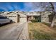 Charming townhome with stone accents, an attached garage, and well-maintained landscaping at 9267 Welby Rd Ter, Denver, CO 80229